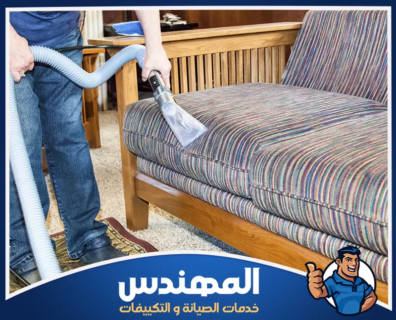 تنظيف كنب مخمل بحفر الباطن 0546176127 شركة المهندس رجل يعمل على تنظيف أريكة بواسطة مكنسة كهربائية في شقة بحفر الباطن.